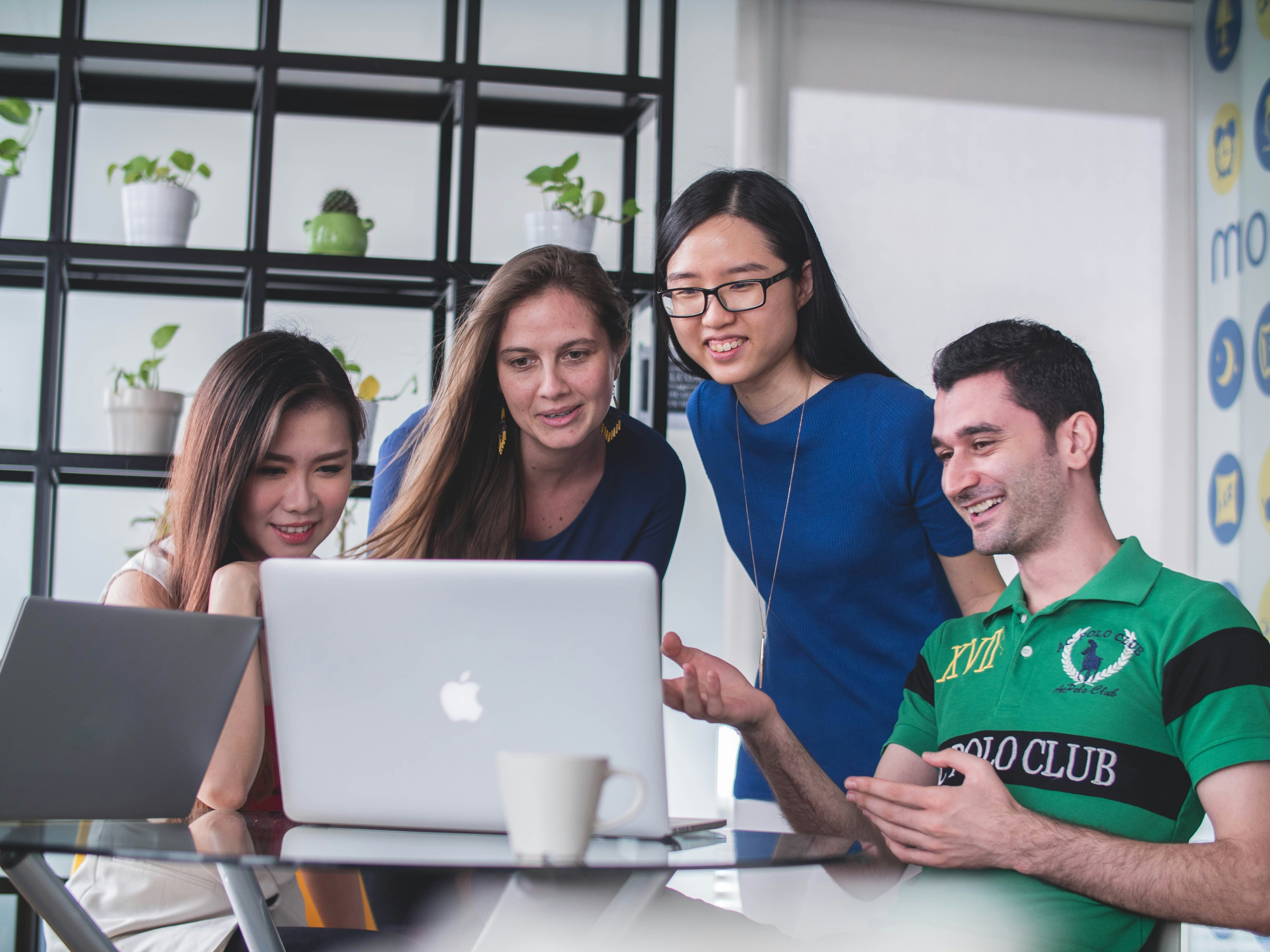 Group of employees looking at a computer